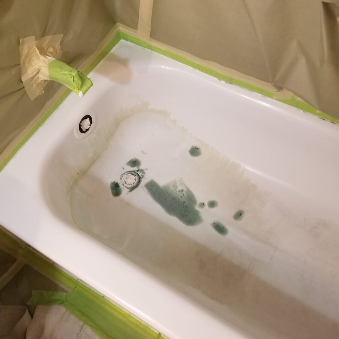 Damaged bathtub with staining and surface wear before repair work